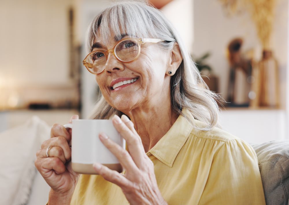 Women holding a cup and smiling
